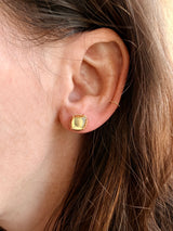 Close-up of an ear wearing Tura Sugden Diamond Slice Earrings in the helix and lobe.