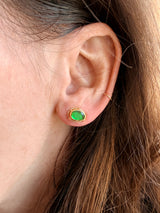 Close-up of an ear with Tura Sugden Green Tourmaline Earrings in recycled yellow gold.