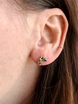 Close-up of an ear with Tura Sugden Green Sapphire Earrings in recycled 18k yellow gold.