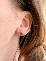 Ear close-up with Tura Sugden Mauve Sapphire Earrings and a small gold hoop in the upper ear.