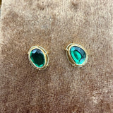 Tura Sugden Green Tourmaline Earrings in recycled gold, shown on a textured brown surface.